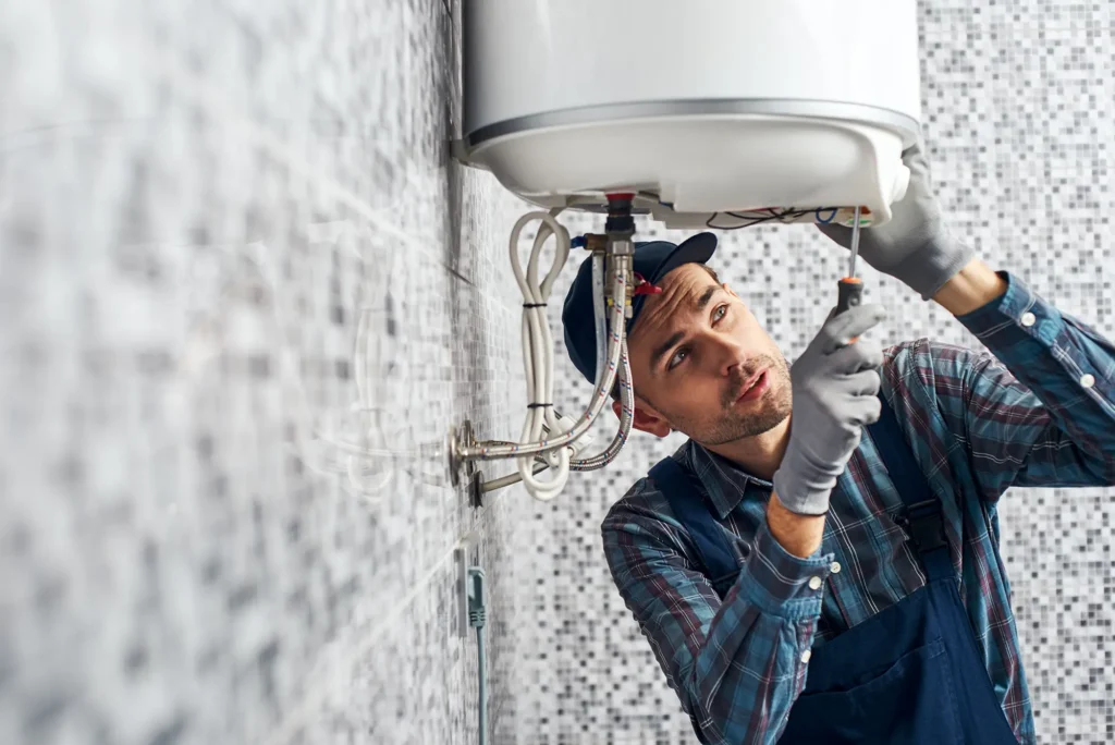 Heat pump technician repairing a hot water system in Perth, ensuring efficient home heating and cooling.